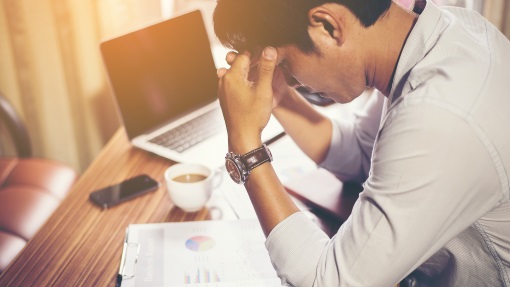 stressed-man-looking-at-reports